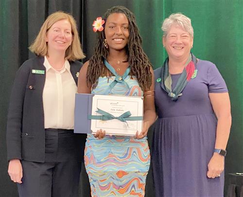 Gaia Godinho poses with her Gold Award from the Girl Scouts.